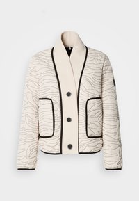 Krēmkrāsas kaprons jaka ar melniem abstraktiem diegiem, melnām pogām, lielu šaļļu apkakli, divām priekšējām kabatām un melnu apmali malās un aprocēs.