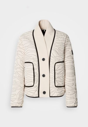 Cremefarbene, gesteppte Jacke mit schwarzem abstraktem Steppmuster, schwarzen Knöpfen, großem Schalkragen, zwei Vorderentaschen und schwarzem Besatz an Kanten und Bündchen.