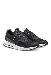 Zwarte hardloopschoenen met een bovenwerk van mesh, grijze accenten, contrasterende witte zool en unieke dempingstechnologie. Voorzien van een veilig vetersysteem.