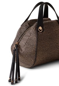 Bolso de mano con cremallera en negro y beige, de forma redondeada, con exterior texturizado, asas de cuero y detalles en metal dorado.