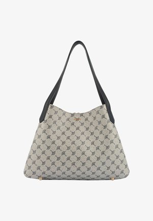 Bež in črno vzorčasta torba za ramo z dolgimi črnimi ročaji, z zlatim logotipom znamke in majhnimi zlatimi nogicami na dnu.