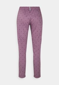 Purple pants featuring a repeating pattern of small, dark symbols. Elastic waistband with a straight-leg design and folded cuff hems.