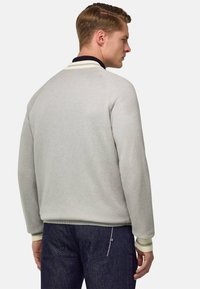 Maglione grigio a maglia con colletto scuro a contrasto, polsini a coste e un motivo testurizzato. Sottolineato da una vestibilità rilassata e un design classico.