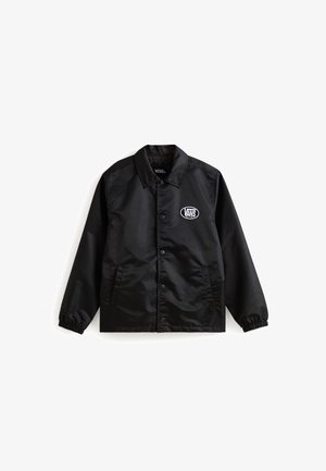 Giacca in nylon nera con colletto, chiusura a bottoni e polsini elasticizzati. Presenta tasche frontali e un logo Vans bianco sul petto.