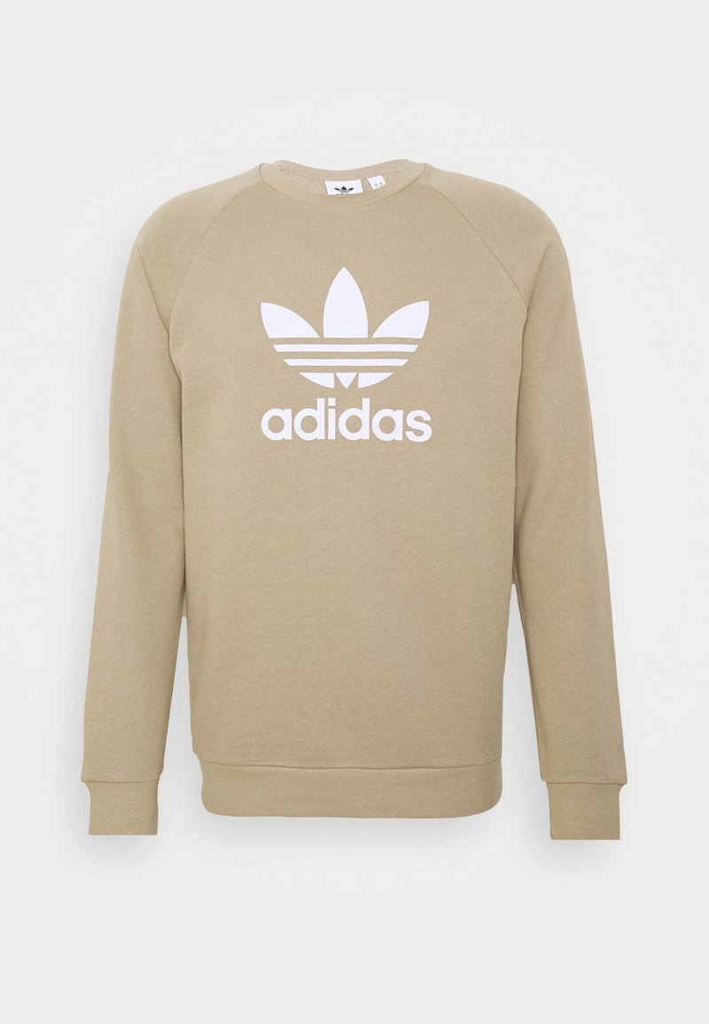 Béžová mikina se dlouhými raglánovými rukávy, žebrovanými manžetami a spodním lemem, s velkým bílým logem adidas a grafikou tří pruhů.