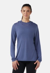 Long-sleeve athletic shirt in light blue fabric, featuring a hood, soft texture, and fitted design with no visible patterns or hardware.