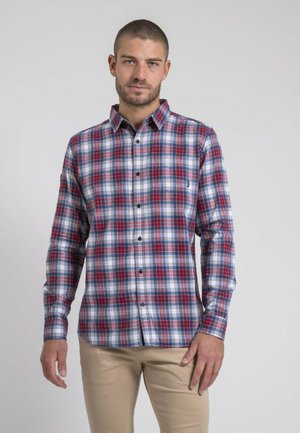 Chemise à manches longues pour homme en tartan avec des motifs à carreaux rouges, blancs et bleus, col boutonné et poche poitrine. Fabriquée en tissu tissé.