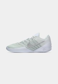 White and light green athletic shoes with a textured upper, sleek design, and silver Nike swoosh accent. Features lacing and padded collar.