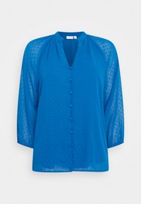 Camisa azul transparente com decote em V, botão frontal e mangas de três quartos. Texturizada com bolinhas salientes por toda a peça.