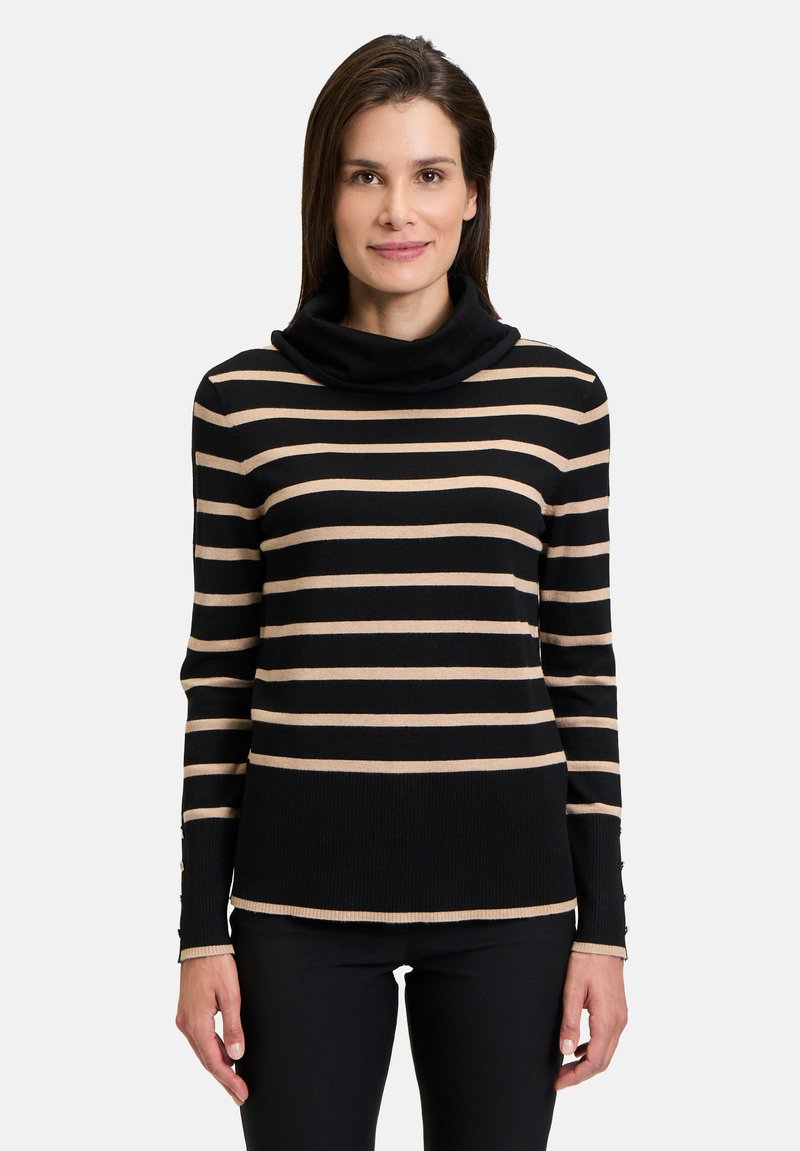 Pull noir et beige à rayures avec un col chal, des poignets côtelés et des accents de boutons sur les manches. Texture lisse, design ajusté.