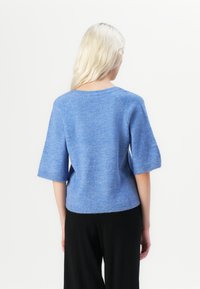 Light blue knit sweater with short, wide sleeves and a rounded neckline. Textured fabric, ribbed hem, and plain back design.