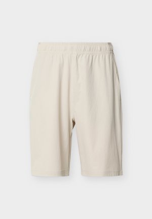 Beige shorts med elastik i taljen og sidelommer, knælange, lavet af letvægtsstof, vist mod en ensfarvet hvid baggrund.