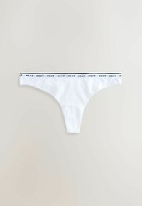 String blanc avec une ceinture élastique noire et blanche répétant le mot "NEXT" sur un fond neutre.