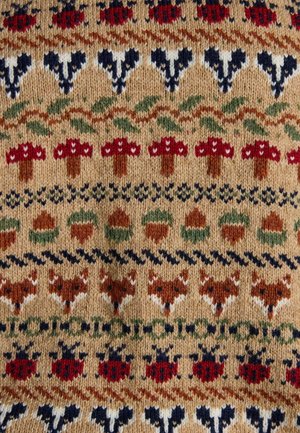 Knit fabric featuring a multi-colored pattern of red mushrooms, acorns, and foxes on a tan background with dark blue and green accents.