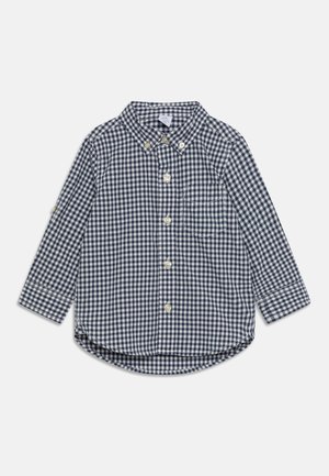Chemise à manches longues à carreaux bleu marine et blanc avec col et poche poitrine pour tout-petit ou jeune enfant.