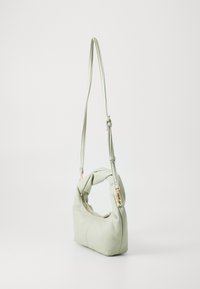 Light green faux leather handbag with a twisted handle, gold hardware, zip closure, and a compact rectangular shape.