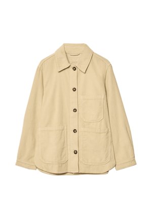 Veste en velours côtelé beige avec un col, une fermeture à boutons à l'avant, deux poches plaquées et une poche poitrine. Texture douce.