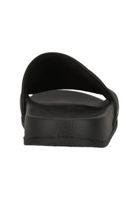 Black slide sandal with a wide strap, flat sole, textured surface, and minimalist design. Made of durable synthetic material.