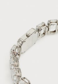 Silver-tone wristwatch featuring a rectangular dial, a smooth case, and a linked bracelet with transparent crystal accents.