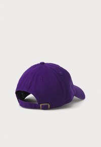 Purple cotton baseball cap with a curved brim, adjustable strap, and visible stitching. Simple design, solid color, and no patterns.