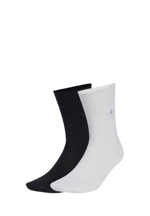 Black and white ribbed socks, featuring contrasting colors, made from cotton blend material; each sock has a subtle logo detail.