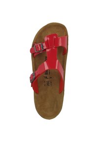 Red, patent leather sandals with two adjustable straps and silver buckles. Cork footbed with a textured surface. Flat sole design.
