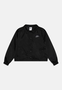 Black nylon jacket with a collared neckline, snap-button closure, and elastic cuffs. Features a small embroidered logo on the left chest.