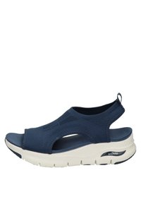 Sandali sportivi blu navy con tomaia intrecciata, punta aperta, ritaglio sul tallone e suola bianca imbottita dotata della tecnologia ArchFit per supporto.