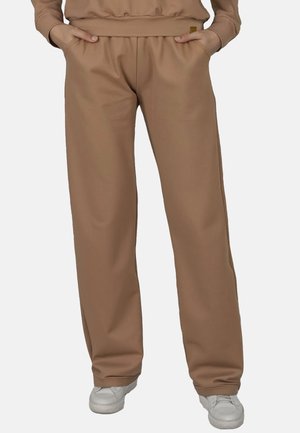 Beige kalhoty širokého střihu z hladké tkaniny, s elastickým pasem na šňůrku a bočními kapsami. Bez viditelných vzorů nebo akcentů.