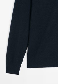 Dark navy knitted sweater featuring a soft texture, a slightly tapered sleeve, and a ribbed hem; minimalistic design with no additional accents.