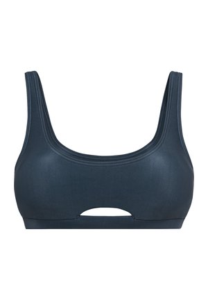 Tumši zila sporta krūšturis ar bieziem siksniņām un taisnām dekoltē līnijām. Tam ir izvietots izgriezums centrā zem krūtīm un gluda tekstūra.