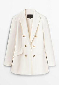 Dobbeltbrystet hvid blazer med spidsrevers, to forreste lommer og messingfarvede knapper, lavet af glat stof med en struktureret design.