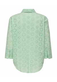 Mint green shirt with embroidered eyelet pattern, long sleeves, collar, and a curved hemline. Lightweight fabric with a textured finish.