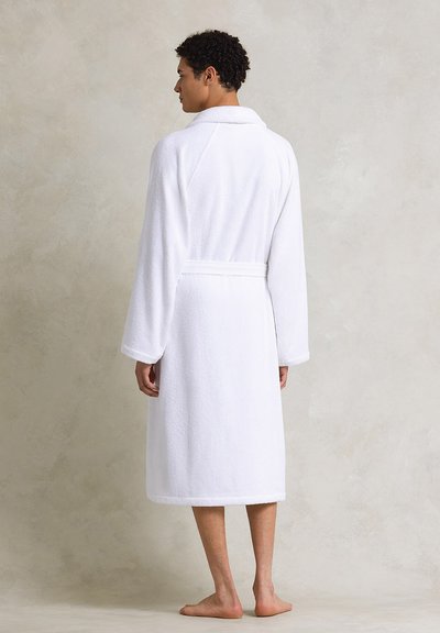 Peignoir de bain en terry blanc avec un col châle, des manches longues et une ceinture à nouer. Caractéristiques : coupe décontractée et longueur au genou.
