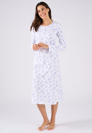 Chemise de nuit à manches longues en coton blanc avec un imprimé floral bleu, décolleté rond et accents de boutons. L'ourlet tombe sous le genou.