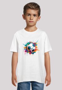 White cotton T-shirt featuring a colorful, splattered graphic of a soccer ball on the front. Short sleeves, crew neck design.