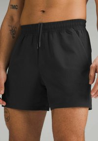 Black swim shorts with an elastic waistband and a drawstring. Smooth texture, knee-length design, and no visible patterns or accents.