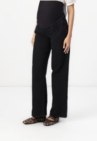 Black wide-leg jeans with front pockets, made of denim fabric. Featured with a comfortable waistband suitable for maternity wear.