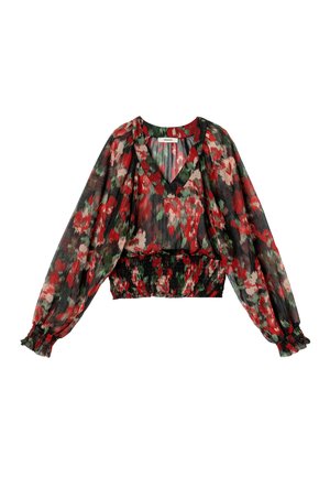 Blouse fleurie en tissu noir transparent avec des fleurs rouges et vertes, manches longues bouffantes, décolleté en V et taille élastiquée.