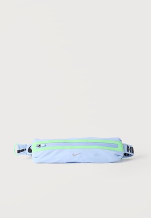 Light blue Nike waist pack with a green zipper and black adjustable strap featuring Nike branding.