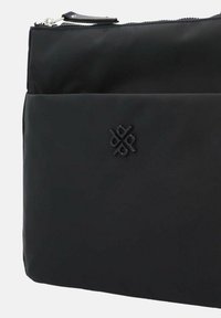 Schwarze Nylon-Clutch mit strukturierter Oberfläche, die ein auffälliges geprägtes Logo und einen Reißverschluss an der Oberseite aufweist. Einfaches und elegantes Design.