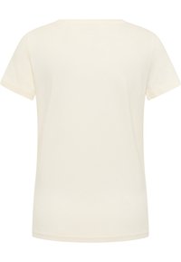 Camiseta de algodón color crema con mangas cortas, escote redondo y una textura suave. Sin patrones ni acentos visibles. Vista trasera.