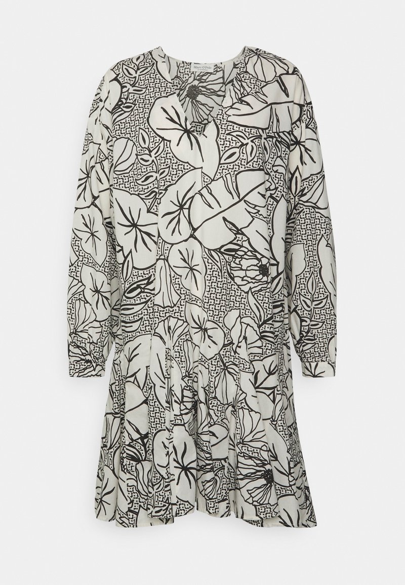 Vestido de manga larga en tela crema con patrones florales y geométricos en negro. Corte holgado con falda fruncida y escote redondo.