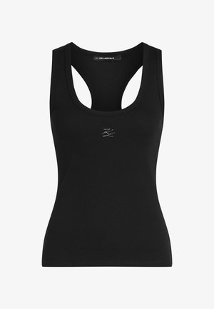 Melnā ribota blūze ar apaļu kakla izgriezumu un izgrieztu muguru, centrā ir neliels balts logotips. Izgatavota no mīksta, elastīga auduma.