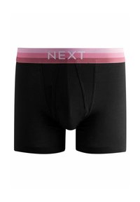 Boxers en coton noir avec une ceinture élastique rayée rose portant le nom de la marque "NEXT" en blanc, conçus pour le confort et l'ajustement.