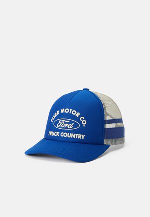 Blue and white trucker cap with "Ford Motor Co. Truck Country" text and Ford logo on front panel, mesh back, and adjustable strap.