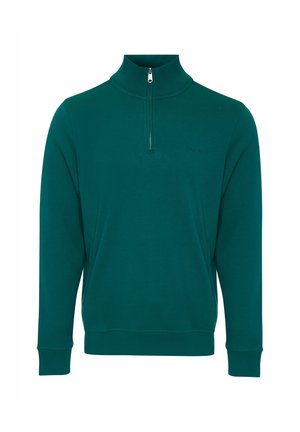 Pull en molleton vert fabriqué dans un tissu doux, avec un col montant à zip quart, des poignets côtelés et un design minimaliste.