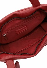 Red leather handbag featuring a textured exterior, zippered interior pocket, and fabric lining with an open storage space.