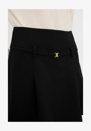 Jupe noire au design élégant avec une fine ceinture rehaussée de doré. Fabriquée en tissu lisse, elle possède une taille structurée et des plis ajustés.