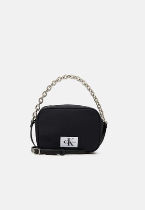 Czarna prostokątna torba na ramię z uchwytem na łańcuszku w kolorze srebrnym, regulowanym paskiem oraz naszywką z logo Calvin Klein Jeans z przodu.